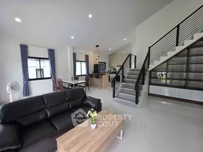 Spacious modern living room with open kitchen and stylish staircase