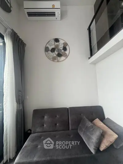 Modern living room with stylish sofa and wall art in a cozy apartment