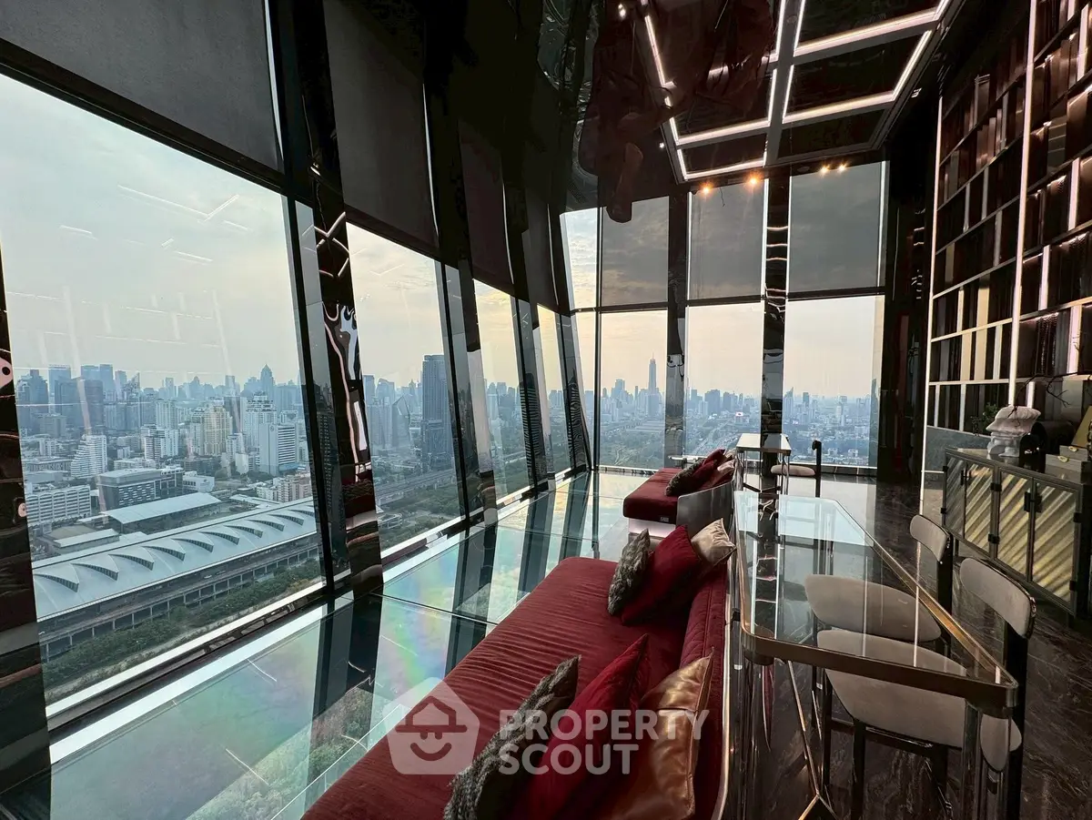 Luxurious high-rise living room with panoramic city views and elegant interior design.