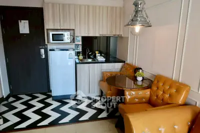 Chic modern kitchen with stylish chevron flooring and cozy seating area.