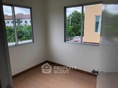 Bright empty room with large windows and tiled floor, perfect for customization.