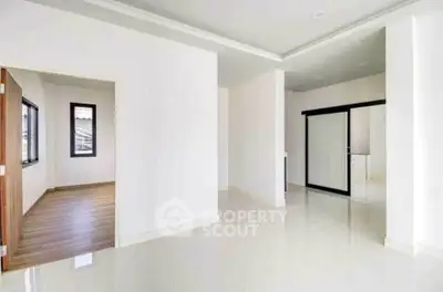 Spacious modern interior with sleek flooring and large windows, ideal for customization.