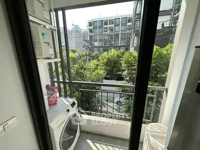 Charming balcony with laundry area and city view, perfect for urban living.