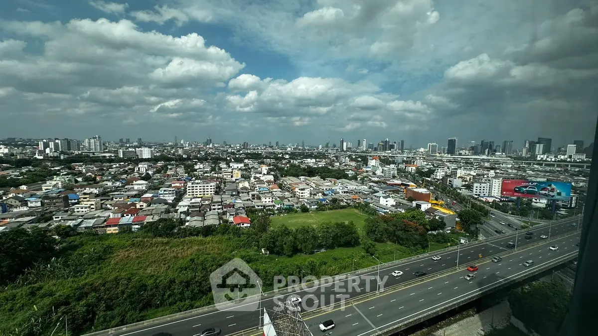 Stunning cityscape view from high-rise building with expansive skyline and lush greenery.