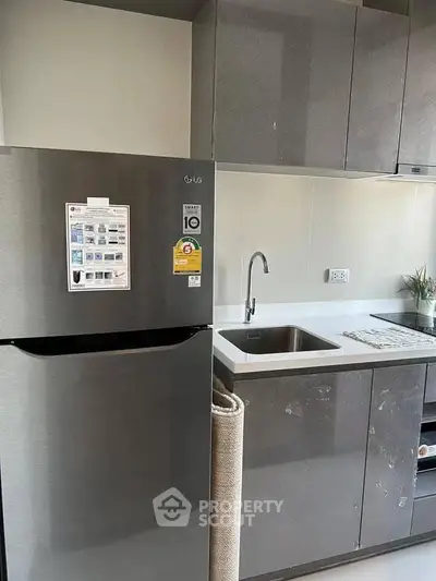 Modern kitchen with sleek cabinets and stainless steel fridge