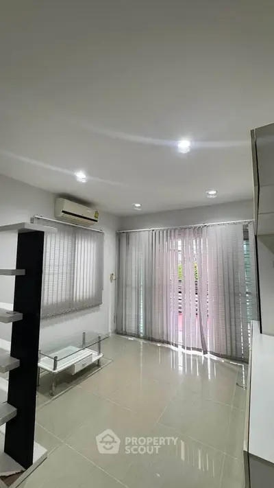 Modern living room with sleek design and large windows for natural light.