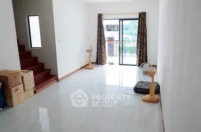 Spacious living room with natural light and balcony access, ideal for modern living.