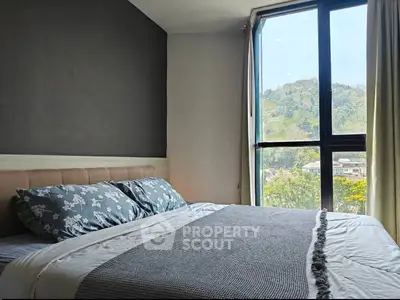 Cozy bedroom with scenic window view and modern decor