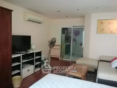 Spacious living room with modern furniture and air conditioning in a cozy apartment.