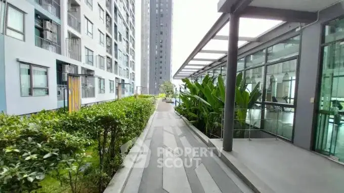 Modern apartment complex with lush greenery and sleek architecture