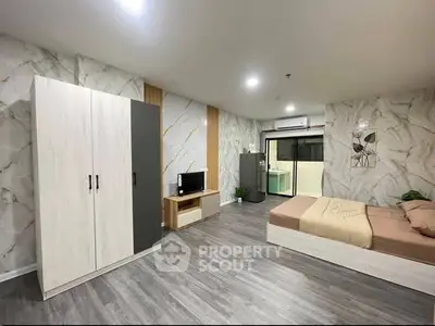 Spacious modern bedroom with stylish decor and ample storage in a luxurious apartment.