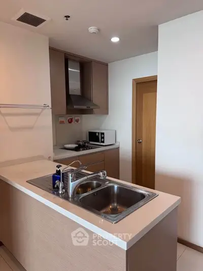 Modern kitchen with sleek cabinetry and stainless steel sink
