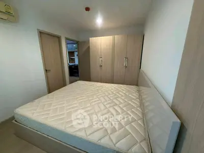 Spacious bedroom with modern wardrobe and comfortable bed in a stylish apartment.