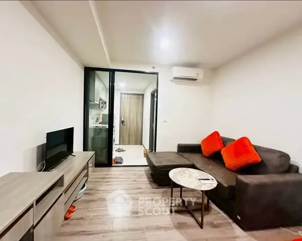 Modern living room with sleek furniture and open layout in a stylish apartment.