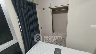 Cozy bedroom with built-in wardrobe and large window for natural light.