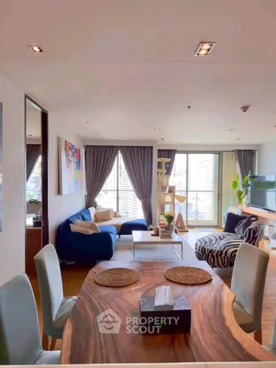 Spacious living room with modern decor and city view, perfect for urban living.