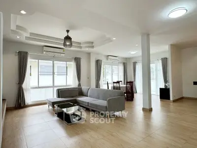 Spacious modern living room with elegant decor and ample natural light