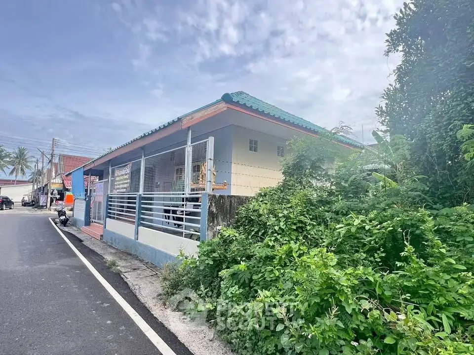 Charming single-story home with lush greenery and secure fencing in a peaceful neighborhood.