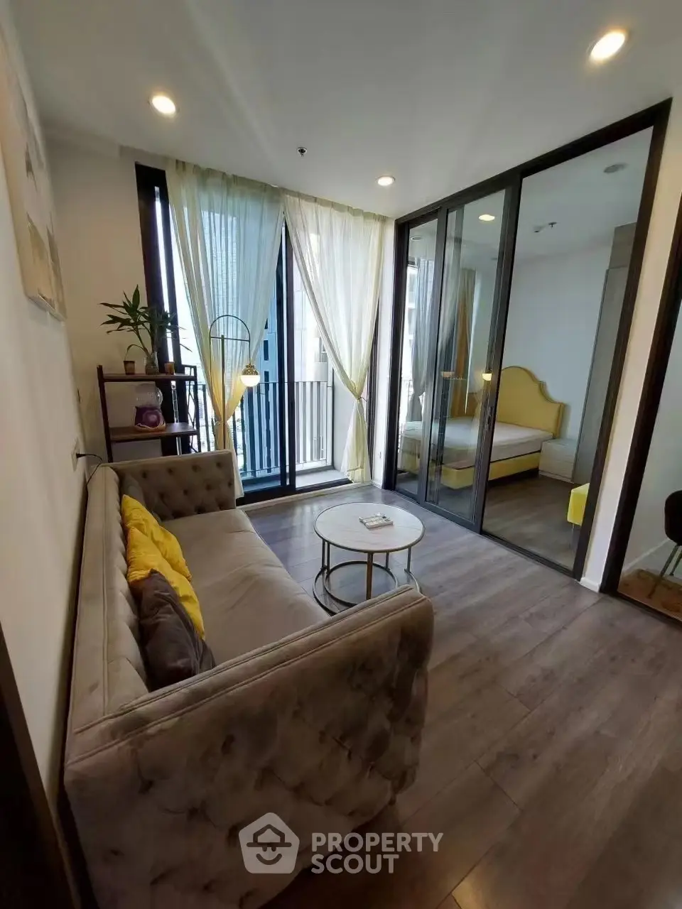 Chic living room with modern decor and balcony access in urban apartment