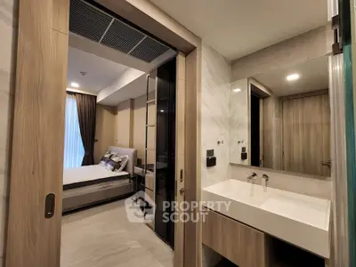 Modern bedroom with ensuite bathroom featuring sleek design and contemporary fixtures.