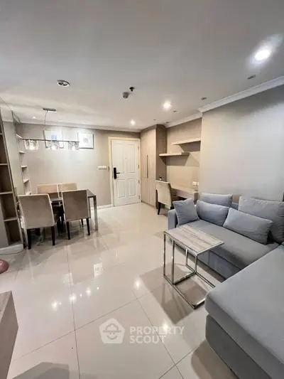 Modern living room with elegant dining area and cozy seating, perfect for relaxation and entertainment.