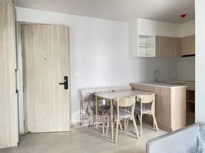 Modern kitchen and dining area with light wood finishes and compact design