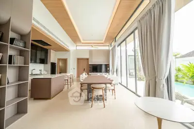 Luxurious open-plan living room with pool view and modern furnishings