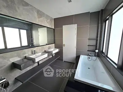 Luxurious modern bathroom with dual sinks and spacious bathtub