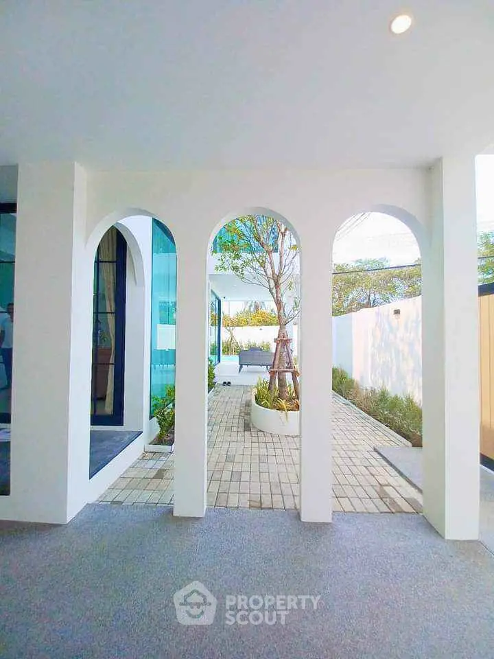 Modern architectural design with elegant arches and serene garden view