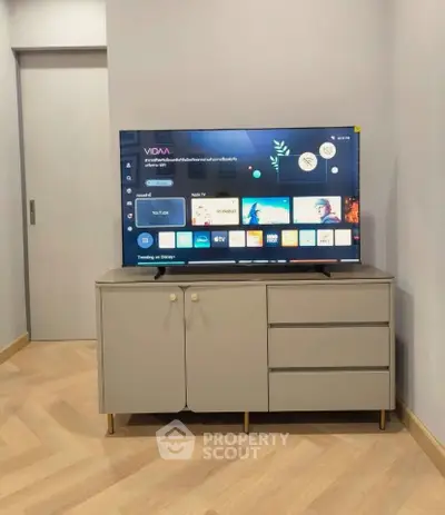 Modern living room with sleek TV stand and smart TV displaying streaming apps.