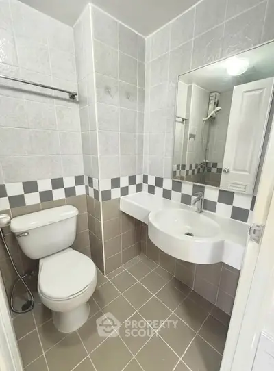 Modern bathroom with sleek fixtures and stylish tile design, perfect for a contemporary home.