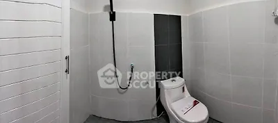 Modern minimalist bathroom with sleek tiles and contemporary fixtures.