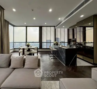 Luxurious open-plan living room with panoramic city views and modern kitchen.