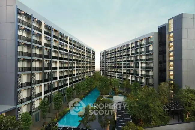 Modern apartment complex with central pool and lush greenery