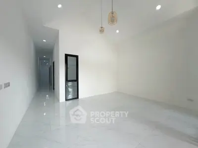 Spacious modern interior with high ceilings and elegant lighting, perfect for customization.