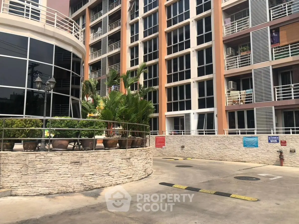 Modern condominium entrance with landscaped greenery and stylish architecture