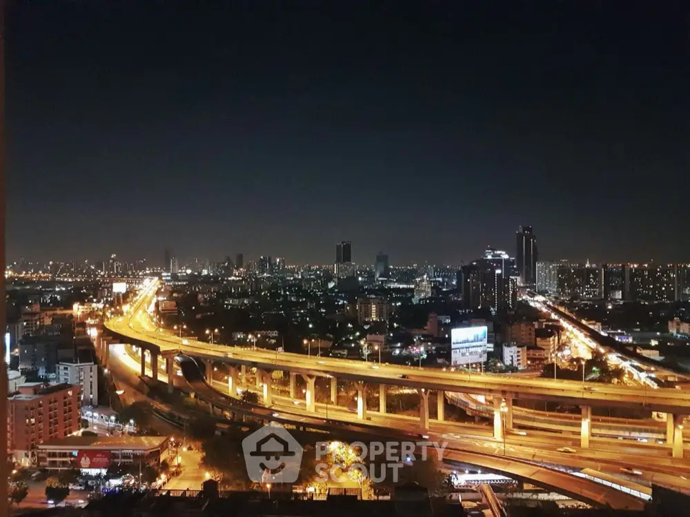 Stunning cityscape view with illuminated highways at night, perfect for urban living enthusiasts.