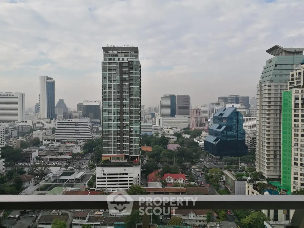 Stunning cityscape view from high-rise balcony overlooking urban skyline.