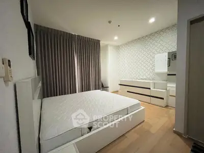Spacious modern bedroom with elegant decor and ample natural light