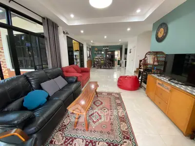 Spacious living room with modern decor and ample natural light, featuring comfortable seating and stylish furnishings.