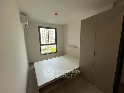 Modern minimalist bedroom with large window and built-in wardrobe