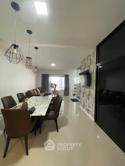 Modern open-plan living and dining area with stylish decor and ample natural light.