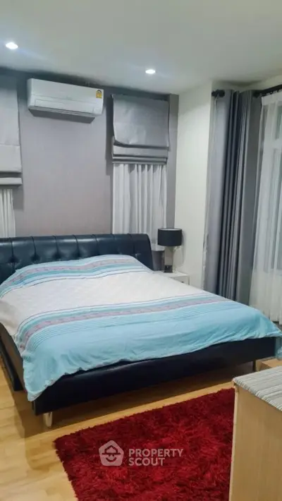 Cozy bedroom with modern decor and air conditioning unit
