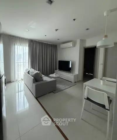 Modern living room with sleek furniture and natural light in a stylish apartment.
