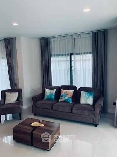 Elegant living room with plush sofa, stylish coffee table, and chic decor accents.