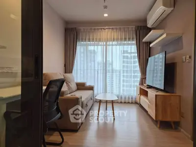 Modern living room with city view, featuring a cozy sofa, large TV, and air conditioning.