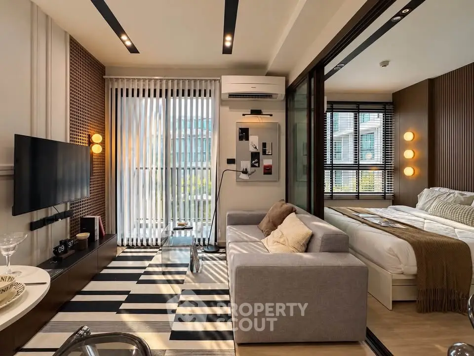 Modern living room with stylish decor and cozy bedroom in open layout apartment