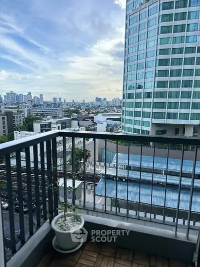 Stunning city view from a modern balcony in a high-rise building.