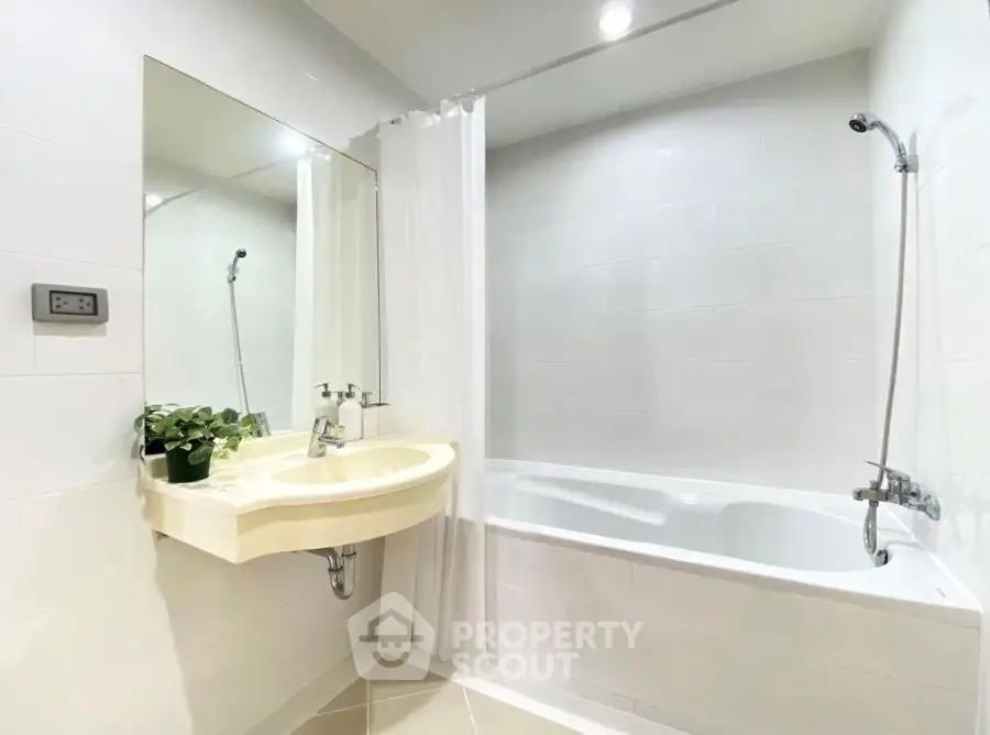 Modern bathroom with bathtub and sleek fixtures in a bright, minimalist design.