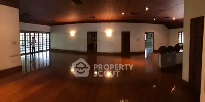 Spacious living room with polished wooden floors and ambient lighting